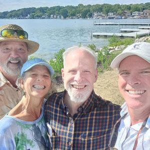 Pictured: John's brother-in-law, sister, John and brother on Pewaukee Lake.